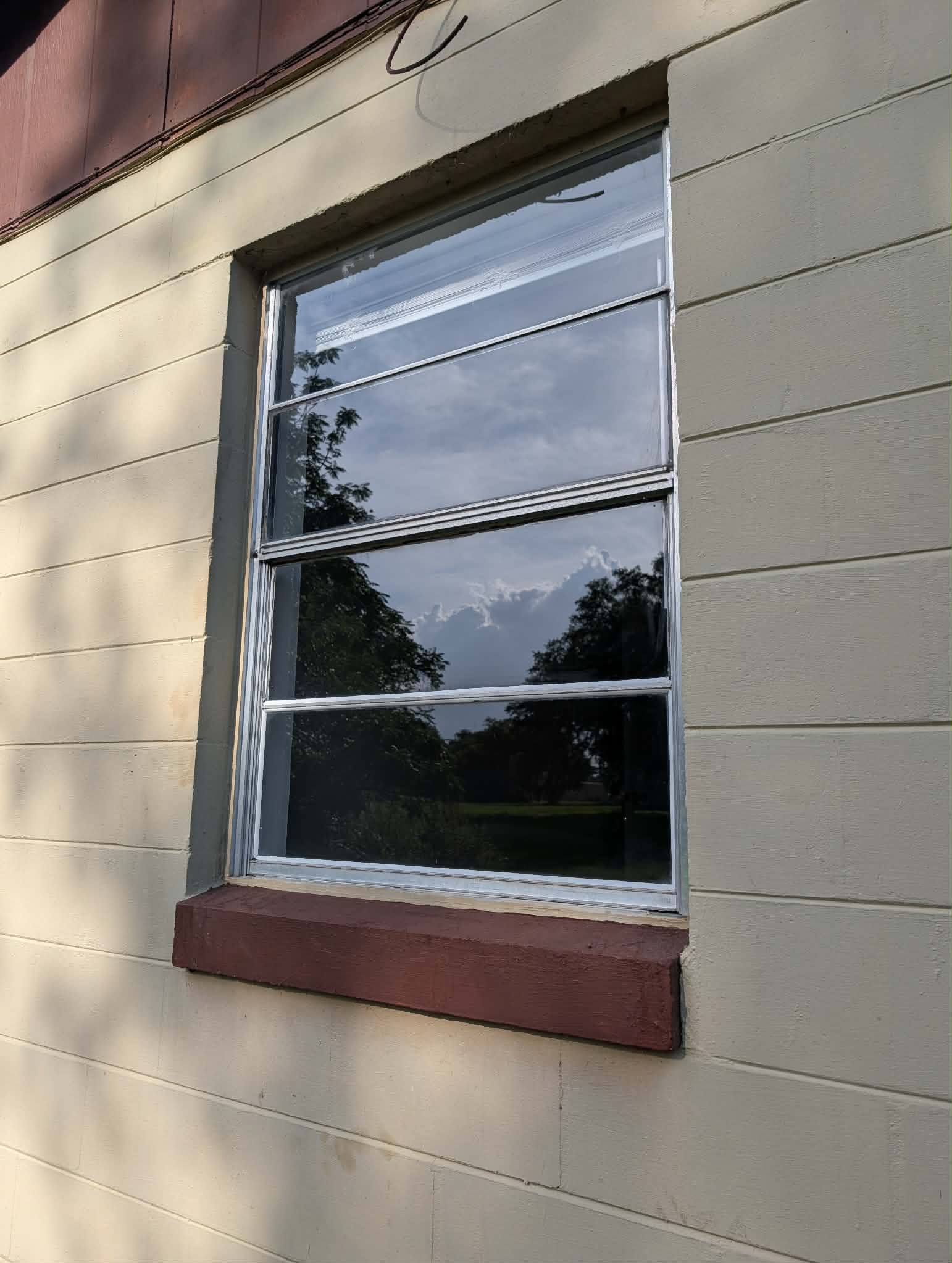 Real job — exterior residential window cleaned to a crystal-clear shine reflecting the Florida sky